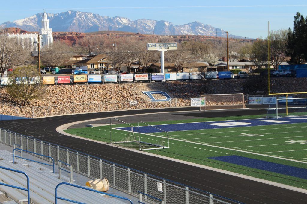 Picture of Dixie High Stadium with houses, temple, and Pine Valley mountain